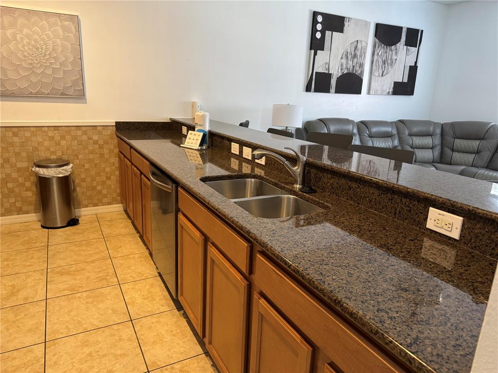 8975 Candy Palm Road Kissimmee, FL 34747 - Photo 8 of 27 a kitchen with granite countertop a sink and a wooden floor