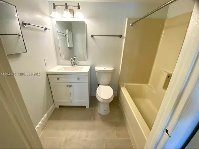 a bathroom with a tub and a shower