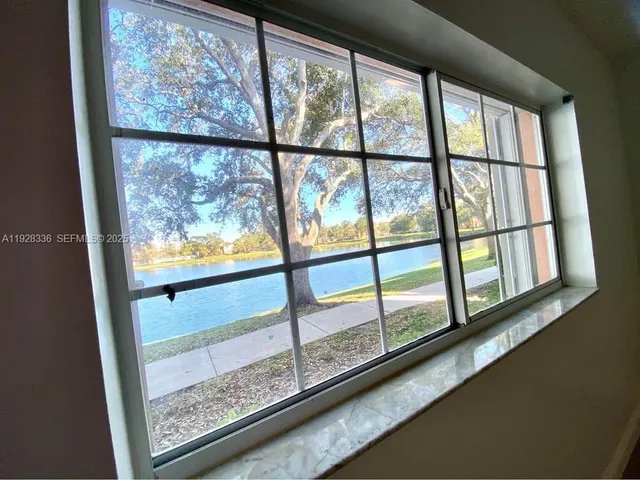 a utility room with mirror and washer