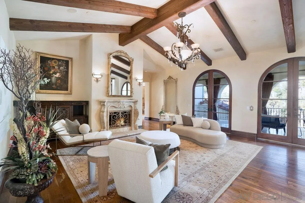 7748 Rd To Zanzibar San Diego, CA 92127 - Photo 18 of 32 a living room with furniture a fireplace and wooden floor