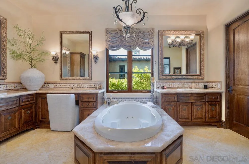 7748 Rd To Zanzibar San Diego, CA 92127 - Photo 21 of 32 a large kitchen with a sink and dishwasher a stove top oven with a granite countertops