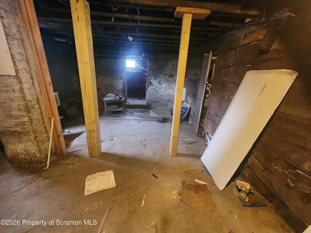 a view of a room with wooden floor and furniture
