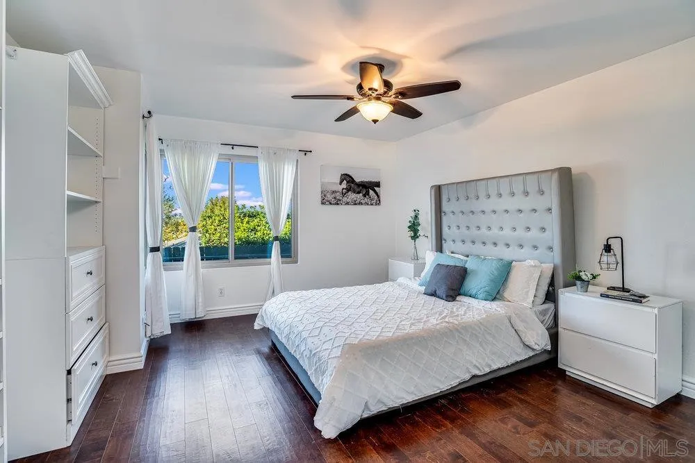 749 Nob Circle Vista, CA 92084 - Photo 11 of 23 a bedroom with a bed and a chandelier