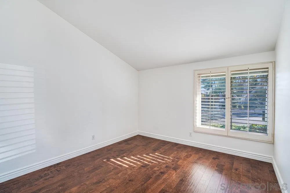 749 Nob Circle Vista, CA 92084 - Photo 15 of 23 a view of an empty room with wooden floor and a window
