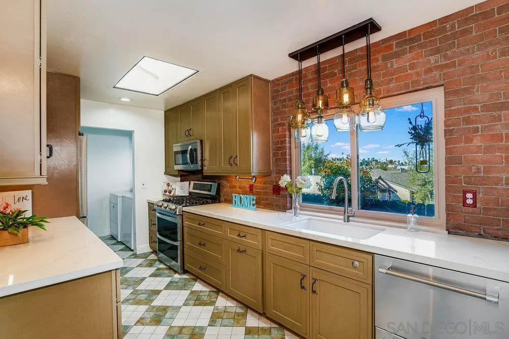 749 Nob Circle Vista, CA 92084 - Photo 8 of 23 a kitchen with stainless steel appliances a sink stove and a refrigerator
