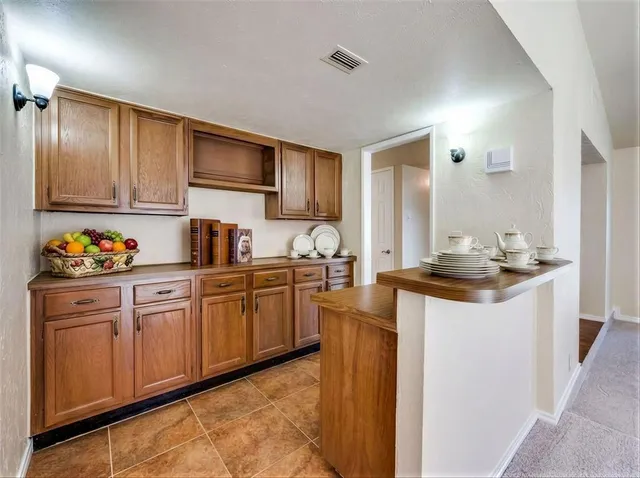 a kitchen with granite countertop a sink stove and cabinets