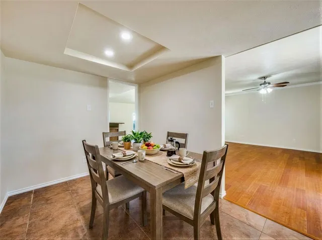 a dining room with furniture and wooden floor