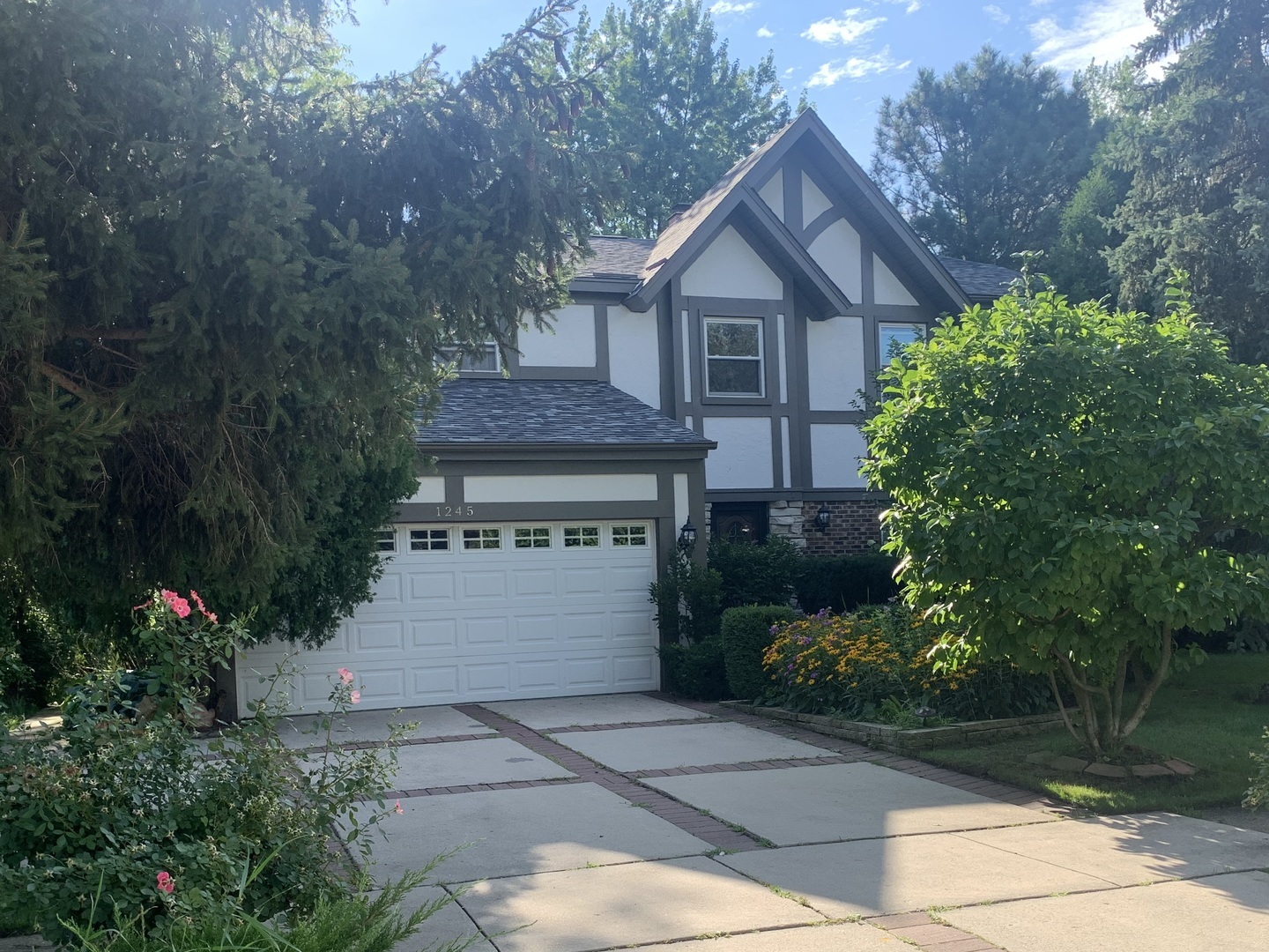 1245 Dayton Road Buffalo Grove, IL 60089 - Photo 1 of 16 a front view of a house with garden