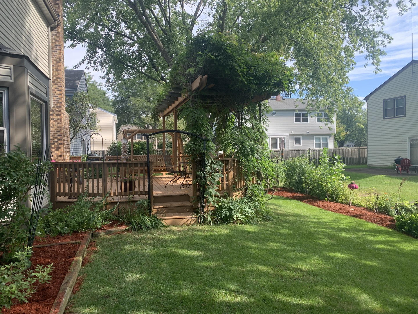 1245 Dayton Road Buffalo Grove, IL 60089 - Photo 14 of 16 a view of a house with a yard and sitting area