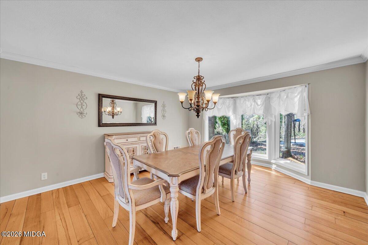 5256 Rivoli Drive Macon, GA 31210 - Photo 14 of 91 a view of a dining room with furniture a chandelier and wooden floor