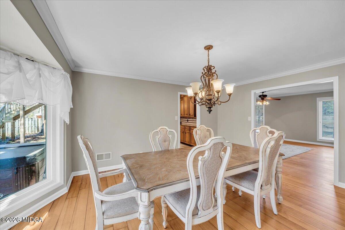 5256 Rivoli Drive Macon, GA 31210 - Photo 15 of 91 a view of a dining room with furniture a chandelier and wooden floor