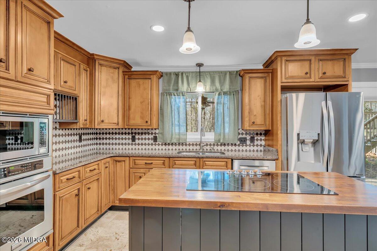5256 Rivoli Drive Macon, GA 31210 - Photo 21 of 91 a open kitchen with granite countertop a sink and dishwasher a stove top oven with wooden floor