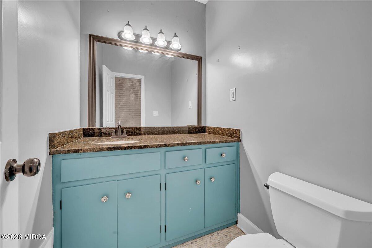 5256 Rivoli Drive Macon, GA 31210 - Photo 31 of 91 a bathroom with a toilet sink and mirror