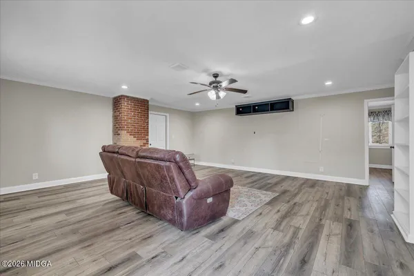 a view of backyard with a large tree and wooden fence