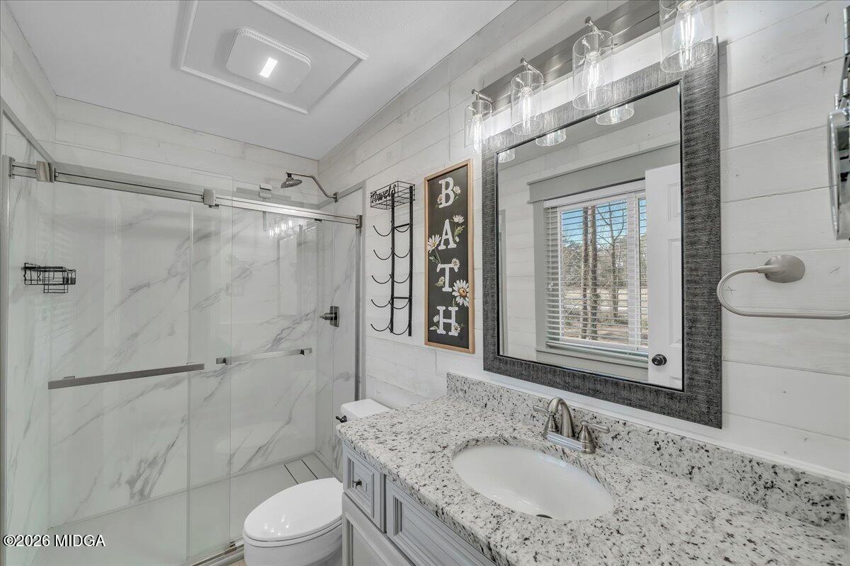 5256 Rivoli Drive Macon, GA 31210 - Photo 45 of 91 a bathroom with a granite countertop sink toilet a shower and a mirror