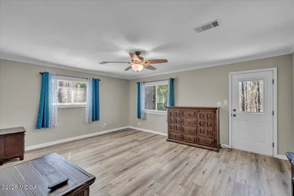 a view of a room with wooden floor and windows