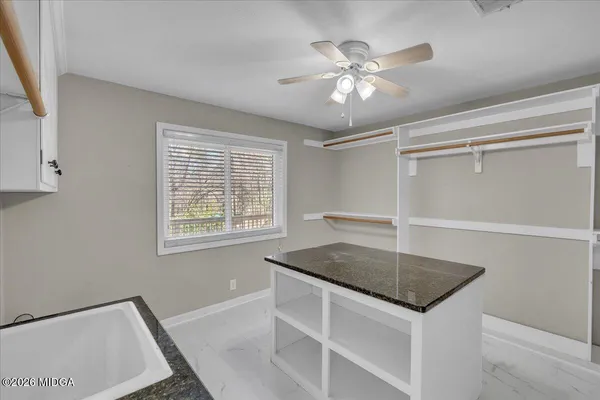 an aerial view of a house with a yard and large tree