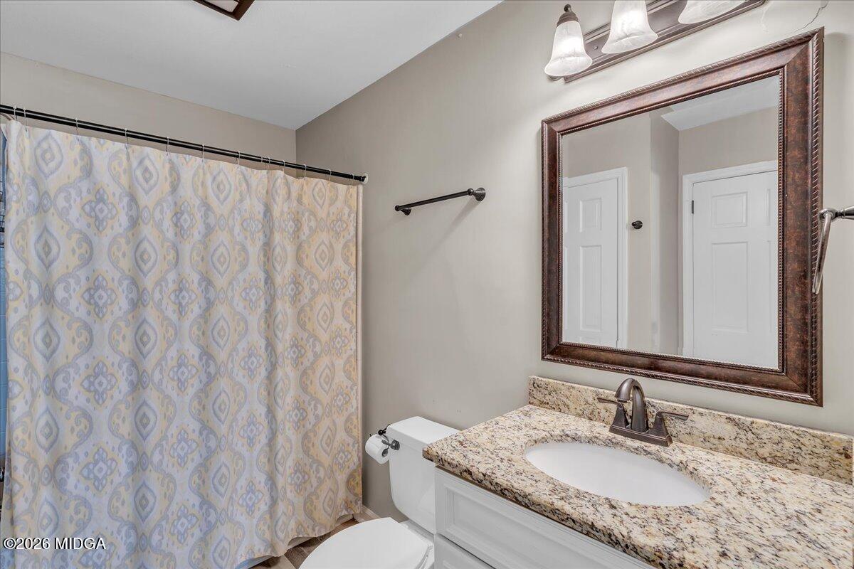 5256 Rivoli Drive Macon, GA 31210 - Photo 58 of 91 a bathroom with a granite countertop sink and a mirror with toilet