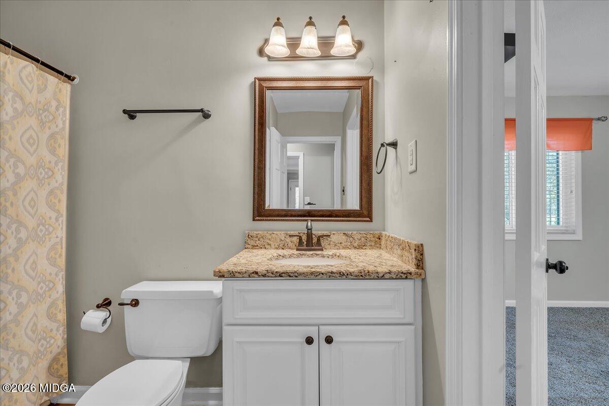 5256 Rivoli Drive Macon, GA 31210 - Photo 59 of 91 a bathroom with a granite countertop sink vanity mirror and toilet
