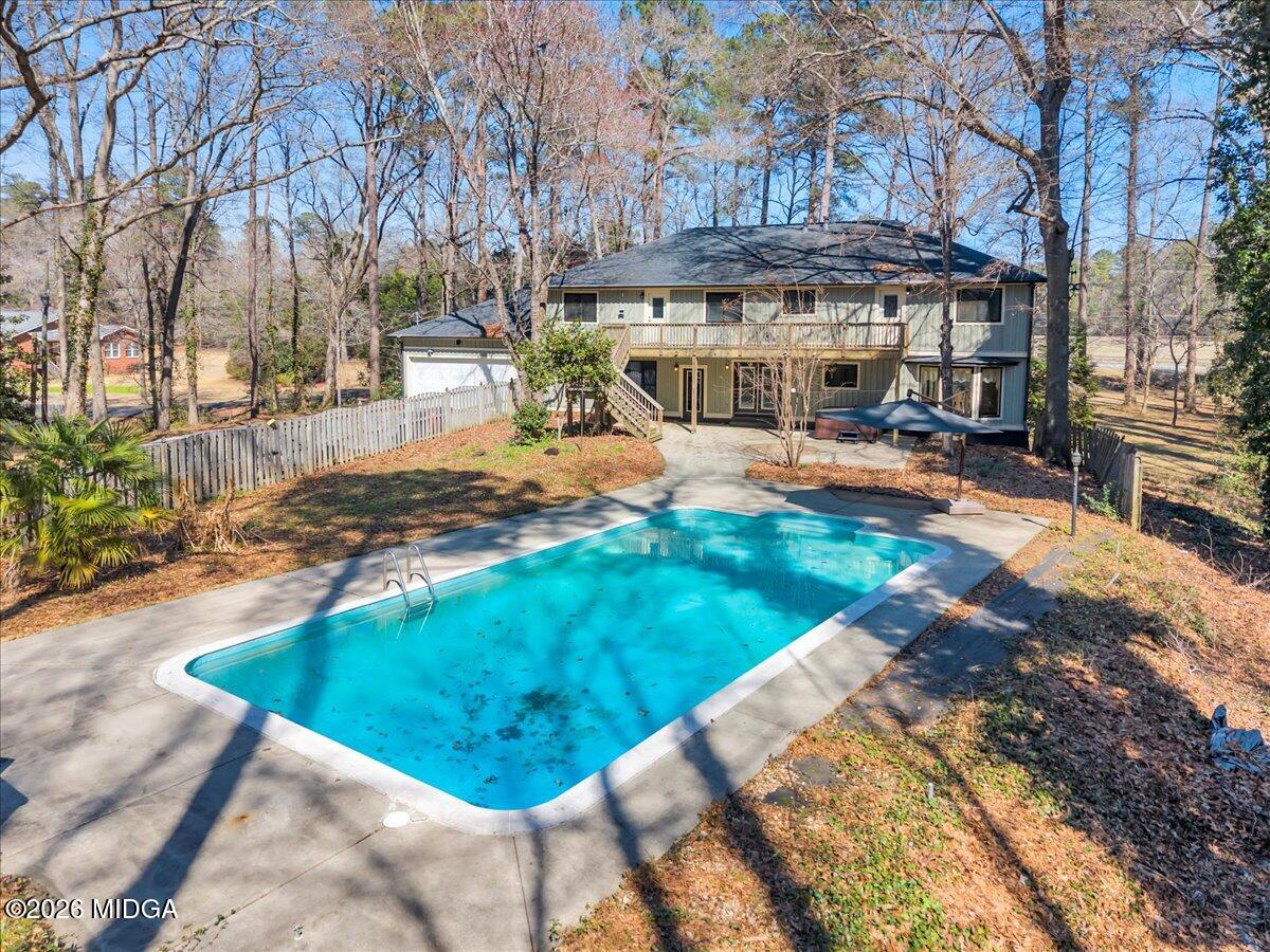 5256 Rivoli Drive Macon, GA 31210 - Photo 79 of 91 a view of a swimming pool with lawn chairs under an umbrella