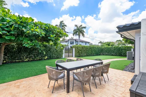 a patio with table and chairs