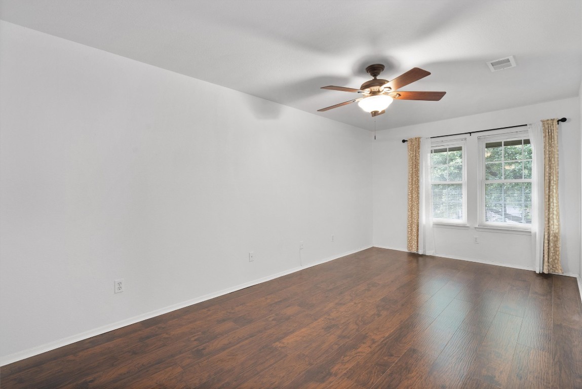 1015 East Yager Lane, Unit 129 Austin, TX 78753 - Photo 20 of 39 a view of an empty room with wooden floor and a window