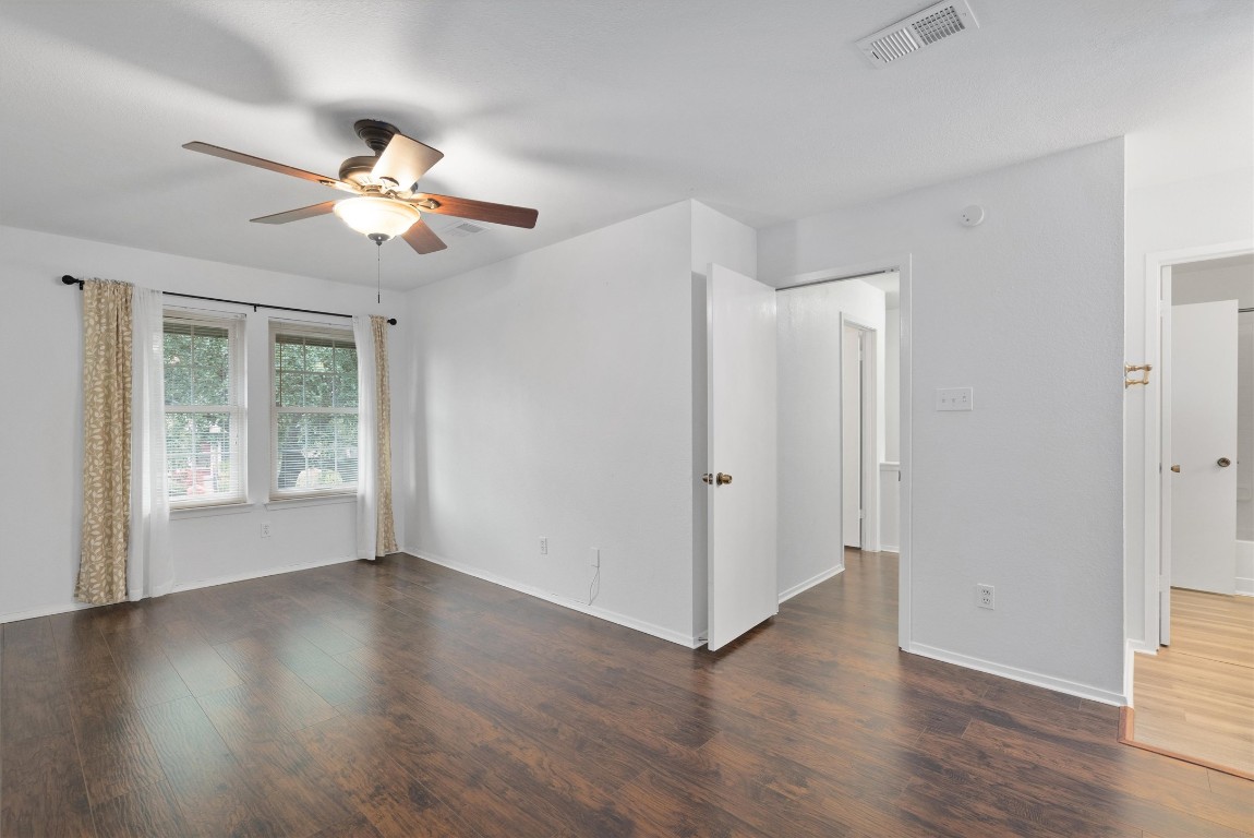 1015 East Yager Lane, Unit 129 Austin, TX 78753 - Photo 21 of 39 a view of an empty room with wooden floor and a window