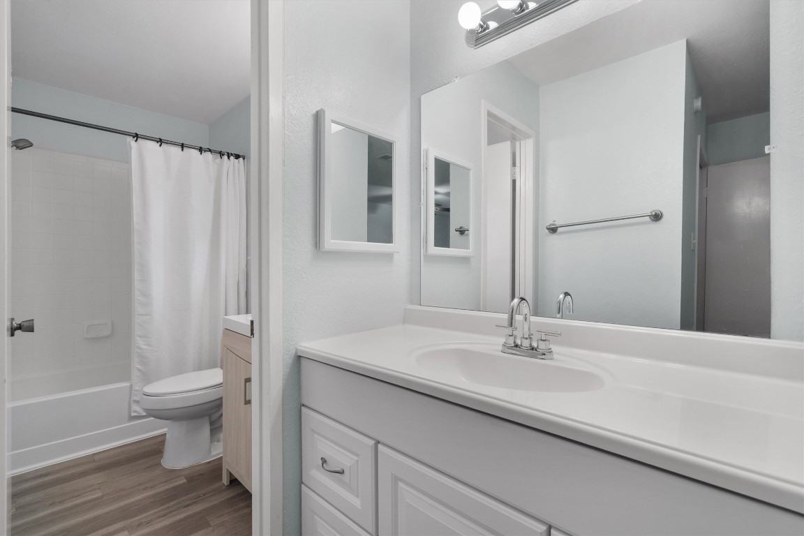 1015 East Yager Lane, Unit 129 Austin, TX 78753 - Photo 23 of 39 a bathroom with a sink a toilet a tub and shower