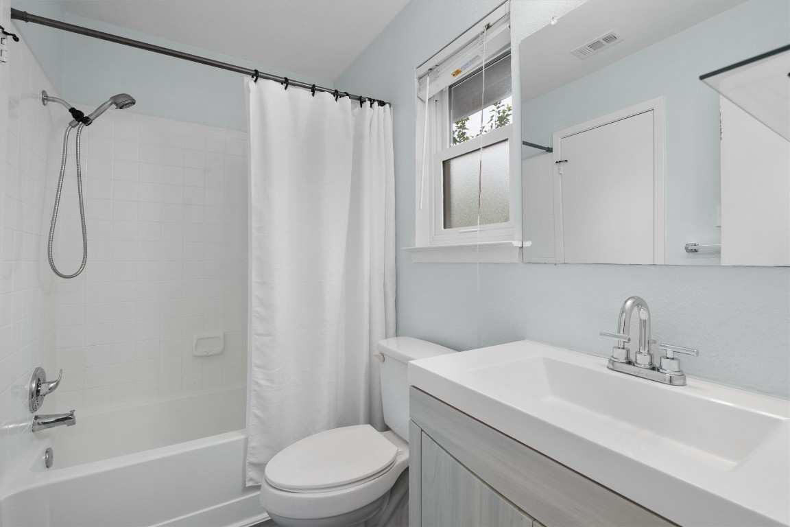 1015 East Yager Lane, Unit 129 Austin, TX 78753 - Photo 24 of 39 a bathroom with a sink a toilet and shower