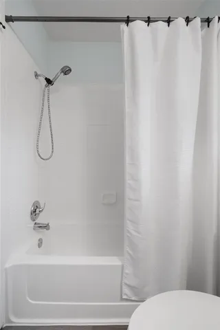 a bathroom with a shower and a toilet