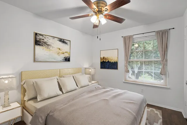 a bedroom with a large bed and a window