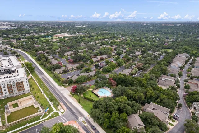 an aerial view of residential houses with outdoor space
