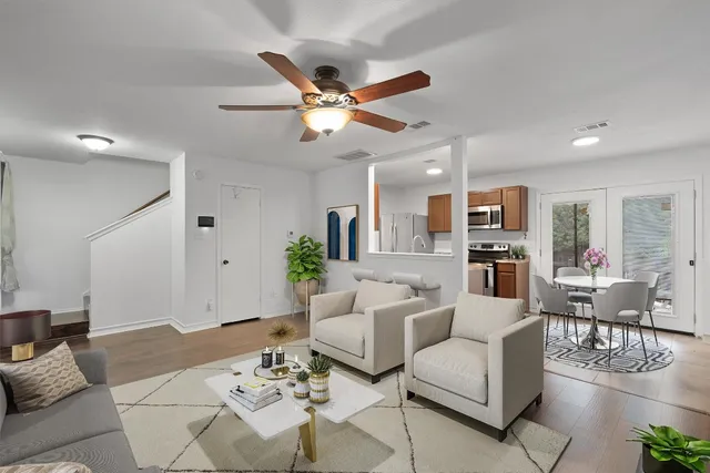 a living room with furniture or kitchen view and a chandelier
