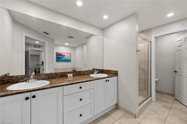 a bathroom with a granite countertop sink mirror and double