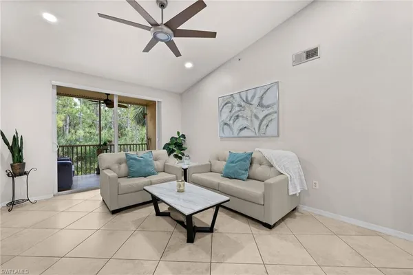 a living room with furniture and a large window