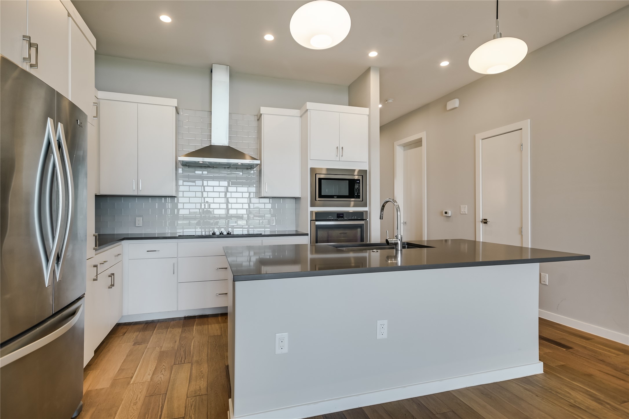 5921 Hiline Road, Unit 2403 Austin, TX 78734 - Photo 13 of 35 a large kitchen with stainless steel appliances a large counter top and a refrigerator