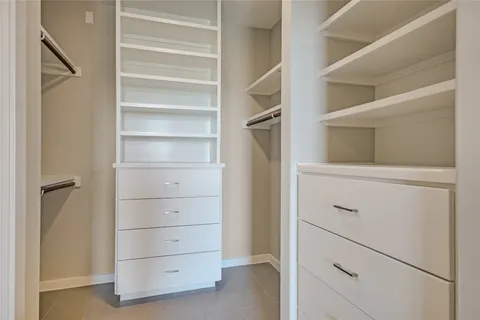 a large kitchen with stainless steel appliances granite countertop a refrigerator and a stove top oven