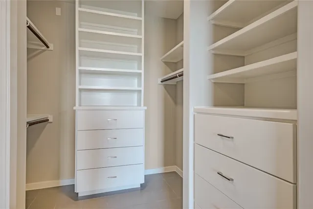 a large kitchen with stainless steel appliances granite countertop a refrigerator and a stove top oven