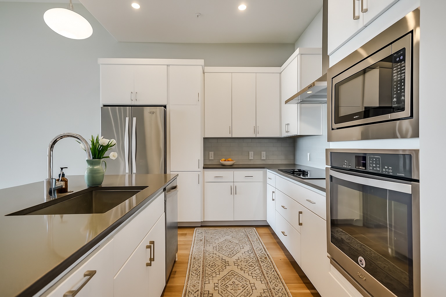 5921 Hiline Road, Unit 2403 Austin, TX 78734 - Photo 3 of 35 a kitchen with stainless steel appliances granite countertop a stove a sink and a microwave