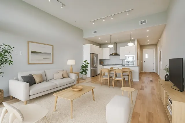 a bedroom with a bed a dresser and large mirror