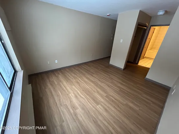 a view of outdoor space with wooden floor and windows