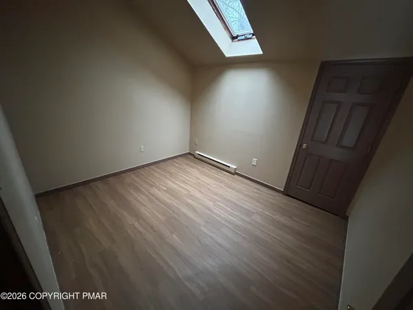 an empty room with wooden floor