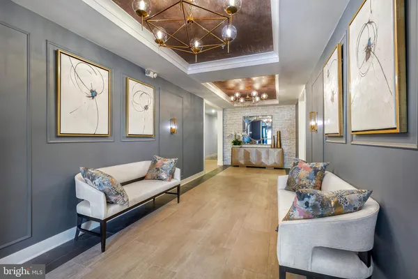 a living room with furniture and a chandelier