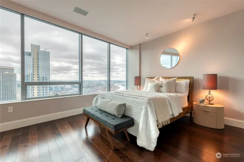 a bedroom with a bed and glass window
