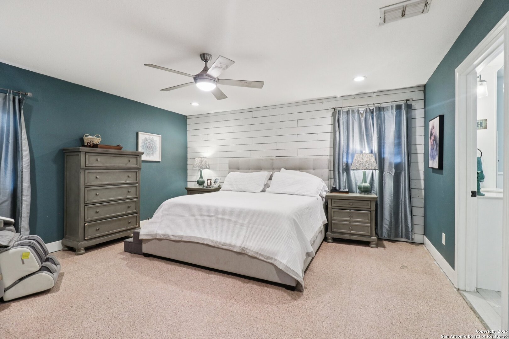 503 Mockingbird Lane Devine, TX 78016 - Photo 15 of 49 a bedroom with a bed and a chandelier