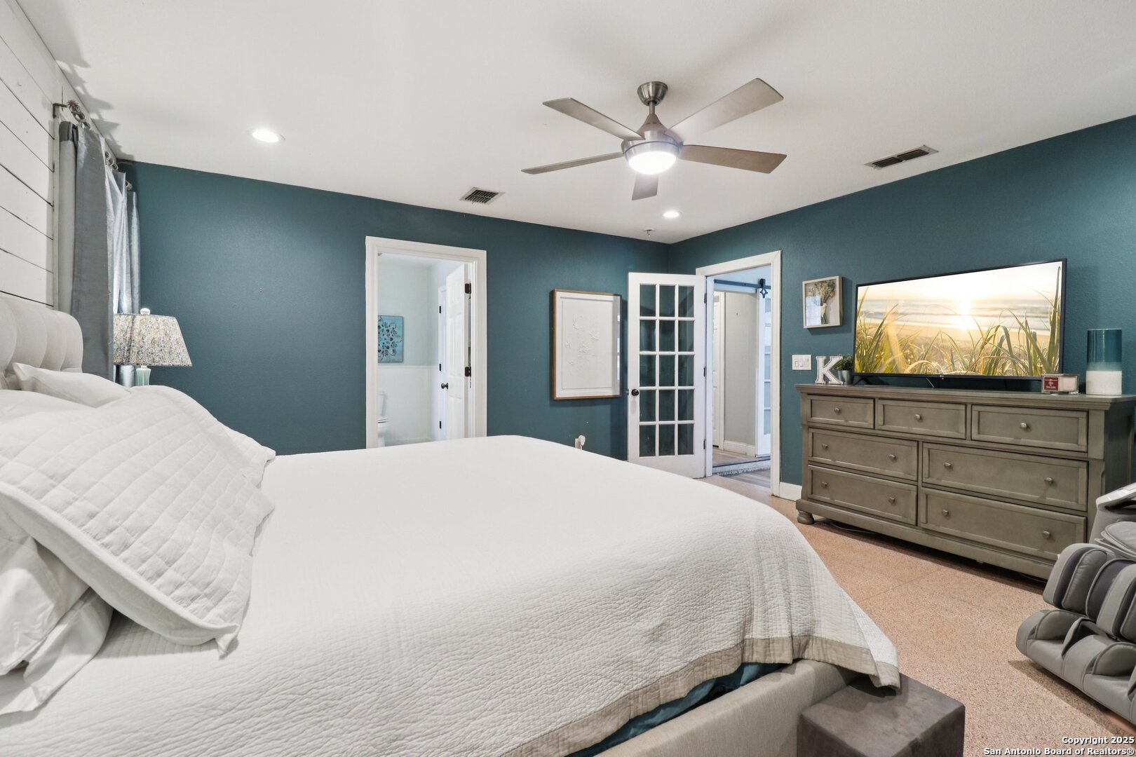 503 Mockingbird Lane Devine, TX 78016 - Photo 16 of 49 a bedroom with a bed and a flat screen tv