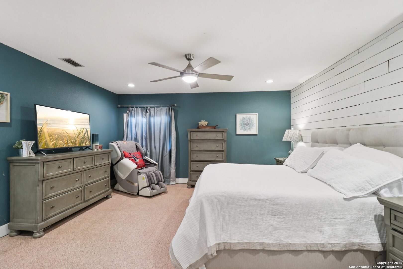 503 Mockingbird Lane Devine, TX 78016 - Photo 17 of 49 a bedroom with a bed and a flat screen tv