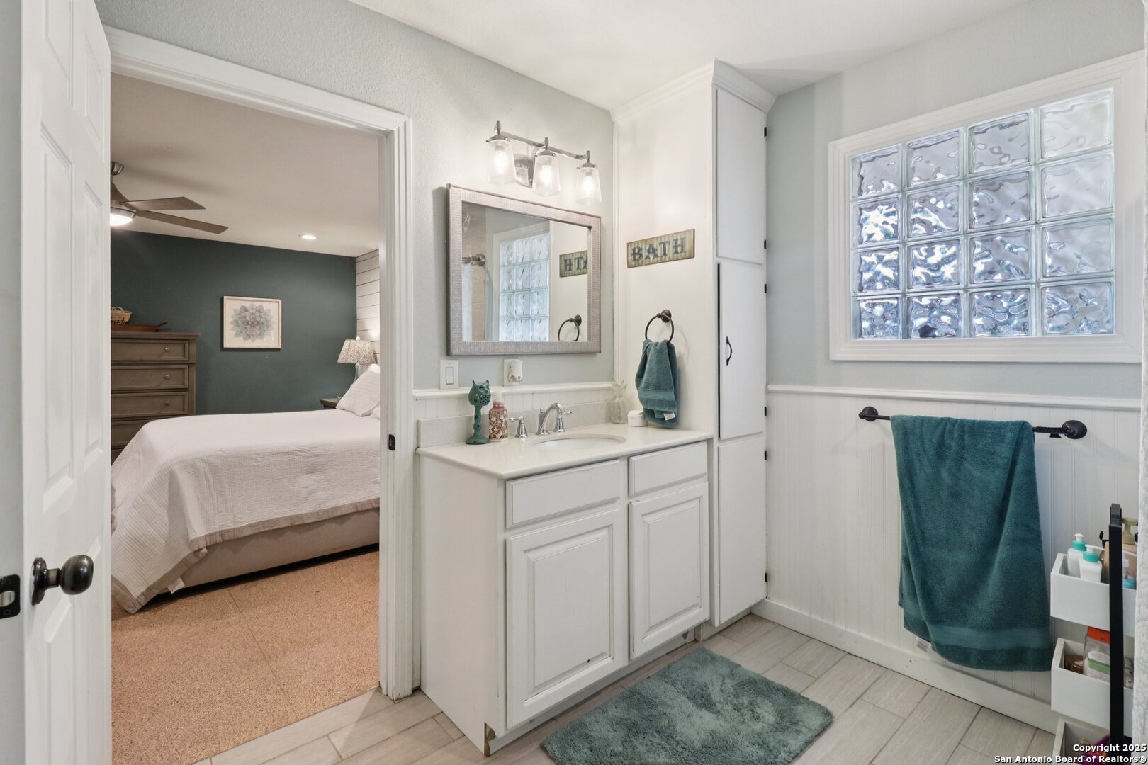 503 Mockingbird Lane Devine, TX 78016 - Photo 19 of 49 a en suite bathroom with sink and mirror