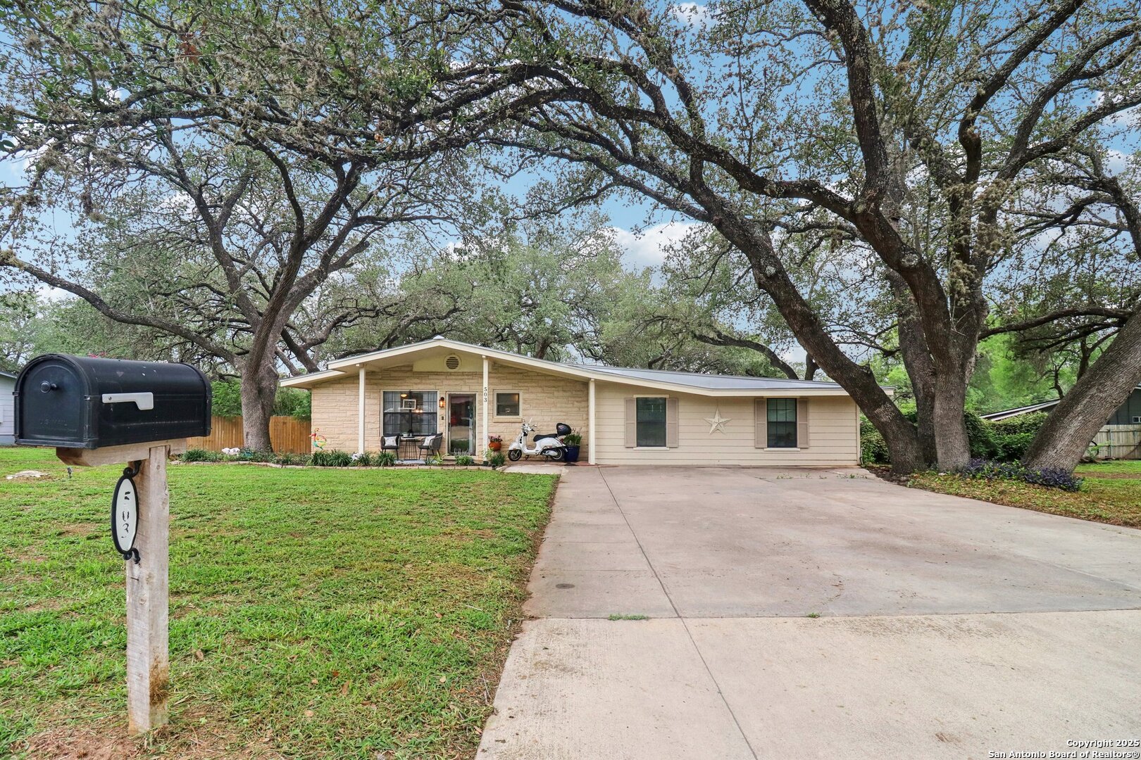 503 Mockingbird Lane Devine, TX 78016 - Photo 2 of 49 a front view of a house with a yard