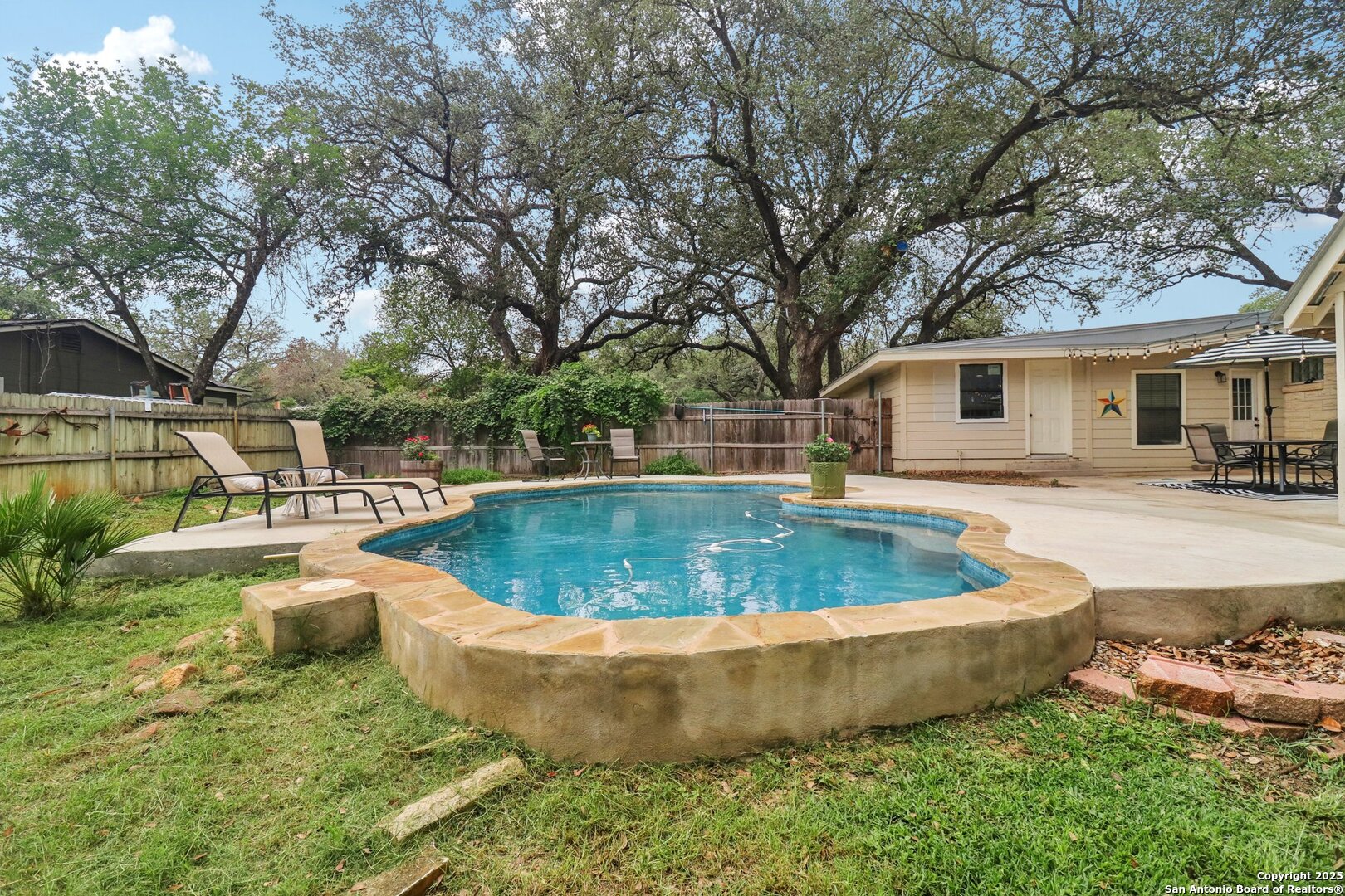 503 Mockingbird Lane Devine, TX 78016 - Photo 33 of 49 a view of a house with swimming pool and sitting area